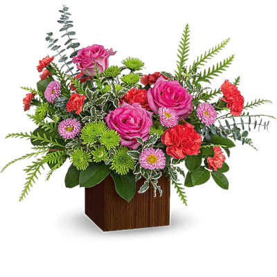 Pink roses and mixed flowers arranged in a wooden cube vase