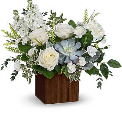 White roses and succulents arranged in a wooden cube vase