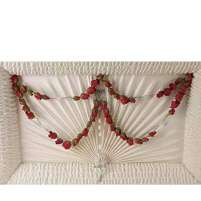 White casket with red rose garland and silver cross detail