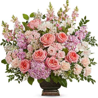 Pink roses and mixed blooms arranged in a dark vase