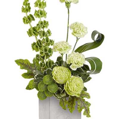Green and white floral arrangement in a square silver vase