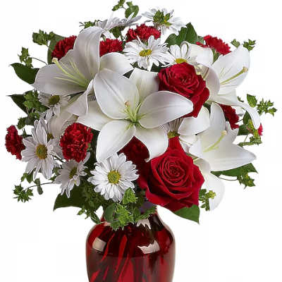 Red roses and white lilies in a red glass vase