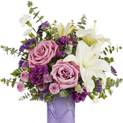 Pink roses and white lilies in a purple glass vase