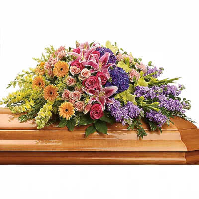 Colorful floral spray on a wooden casket