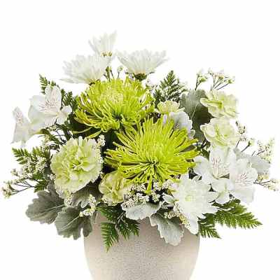 White and lime-green floral arrangement in a beige vase