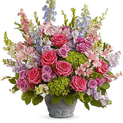 Mixed pink and lavender flowers arranged in a gray vase