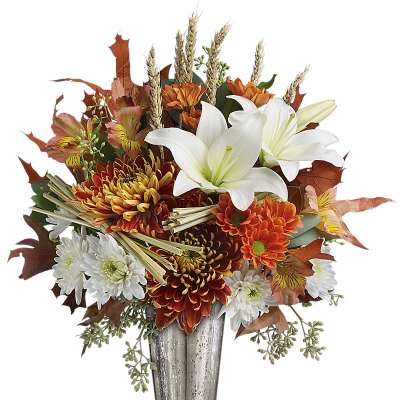 Autumn bouquet of lilies and chrysanthemums in a silver vase