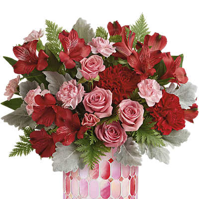 Pink and red floral arrangement in a patterned vase