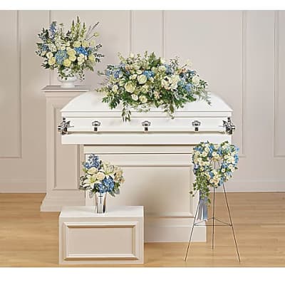 White casket with blue and white floral sprays