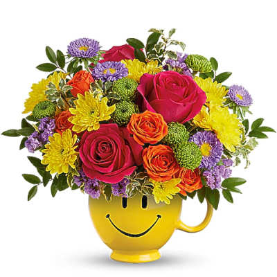 Colorful bouquet in a yellow smiley-face mug