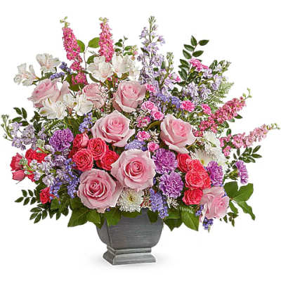 Pink and purple mixed flower arrangement in a gray urn vase