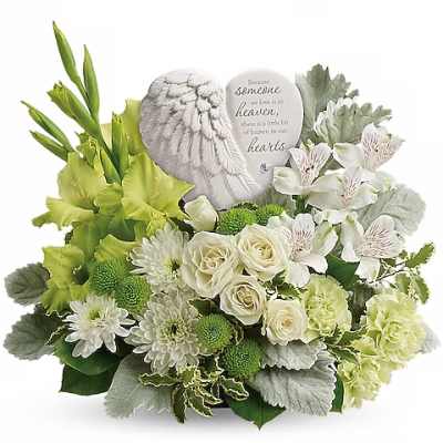 White and green sympathy arrangement with roses and daisies around a memorial plaque