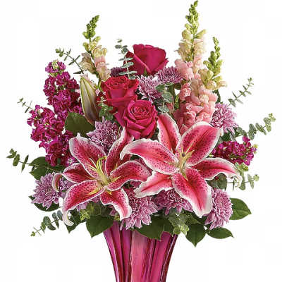 Pink lilies, roses, and mums arranged in a tall magenta vase