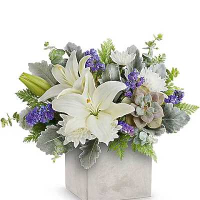 White lilies and purple flowers in a silver square vase