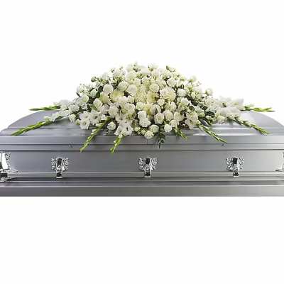 White floral casket spray on a silver casket
