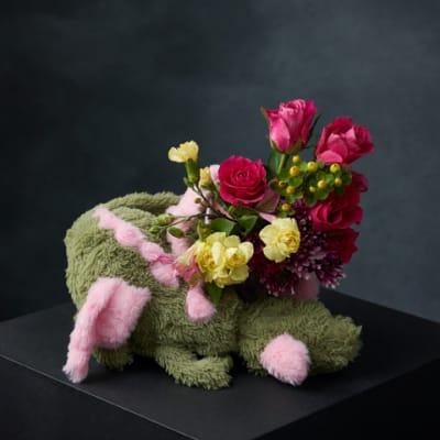 Bouquet arranged in a plush bunny-shaped container with pink and yellow flowers