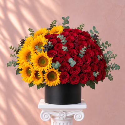 Red roses and yellow sunflowers in a black box arrangement