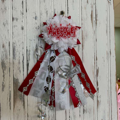 Red and white ribbon award rosette with "AWESOME!" and football-themed streamers