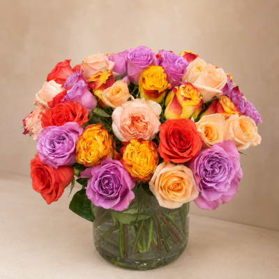 Mixed roses in a clear glass vase