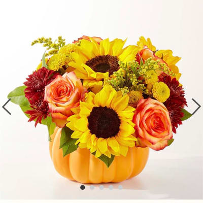 Sunflower and rose arrangement in a pumpkin-shaped container