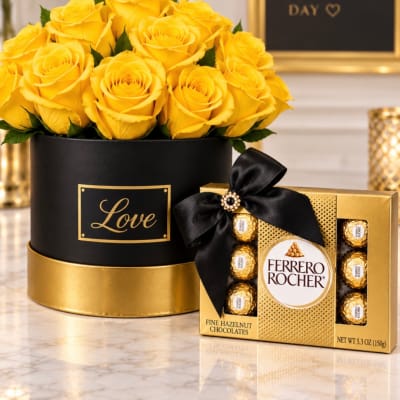 Yellow roses in a black and gold box beside a Ferrero Rocher chocolate box