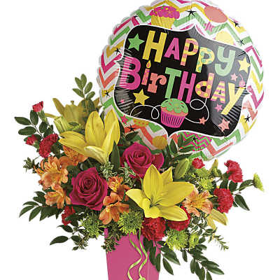 Birthday bouquet with yellow lilies, pink roses, orange blooms and a balloon in a tall pink vase
