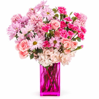 Pink mixed flowers arranged in a tall magenta vase