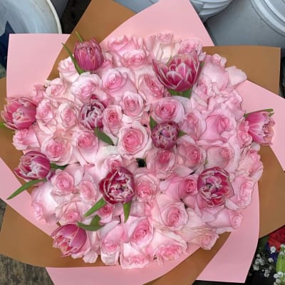 Pink rose and tulip bouquet wrapped in pink and brown paper
