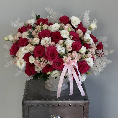 Large bouquet of red, white, and blush roses in a vase