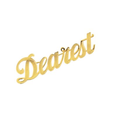 Gold script cake topper reading "Dearest"