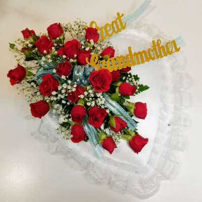 Bouquet of red roses with a blue ribbon and gold grandmother topper