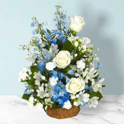 Blue and white floral arrangement in a wicker basket