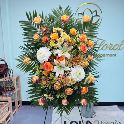 Large floral standing spray with roses, lilies, and white chrysanthemums