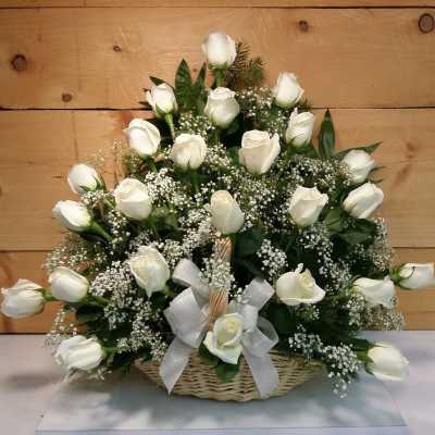 Basket of white roses with baby's breath and a white ribbon