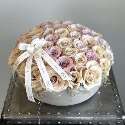 Round bouquet of blush and cream roses with a ribbon bow