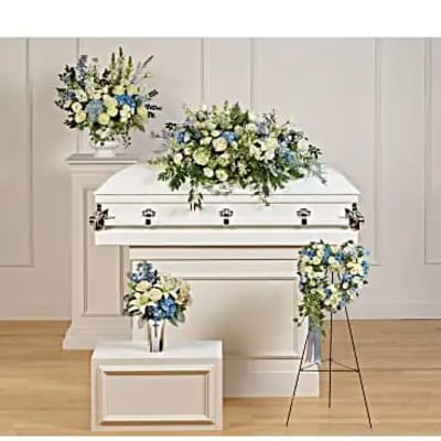 White casket with blue and white floral sprays