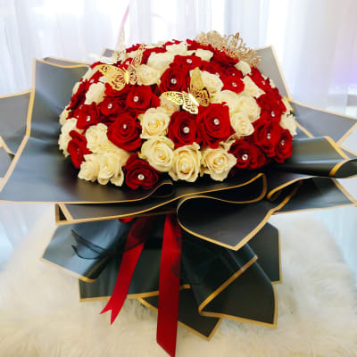Bouquet of red and white roses with gold butterfly accents
