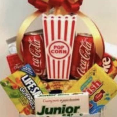 Popcorn bucket gift basket with soda cans and candy