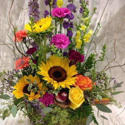 Tall mixed bouquet with sunflowers, roses, and purple blooms