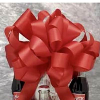 Gift basket with Coca-Cola bottles, candy bars, and a large red bow