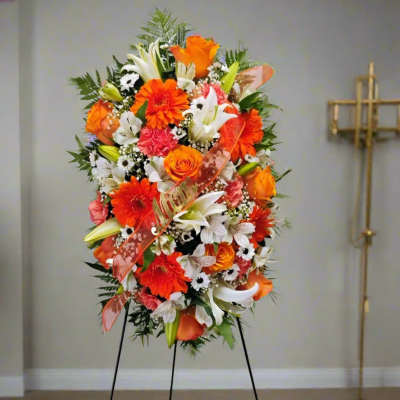Tall standing floral spray with orange, white, and pink blooms