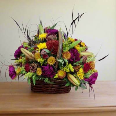 Mixed flower arrangement in a wicker basket