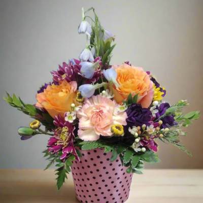 Colorful mixed bouquet in a pink polka-dot pot