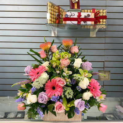 Mixed bouquet in a rectangular container with pink, white, and lavender flowers