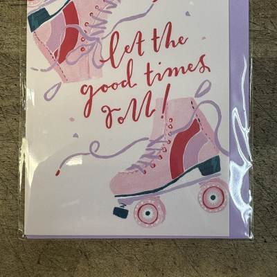Greeting card with pink roller skates and the words let the good times roll in red script