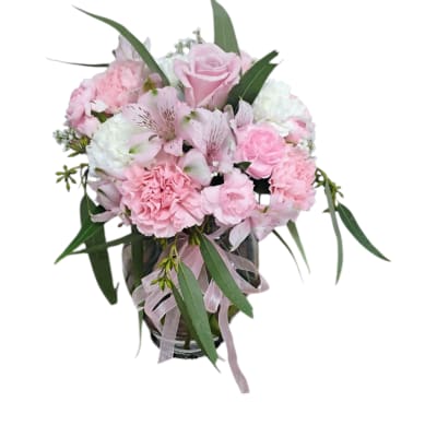 Pink and white bouquet in a glass vase with a ribbon