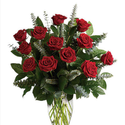 Red roses arranged in a clear glass vase