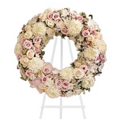 Pastel floral wreath on a white stand