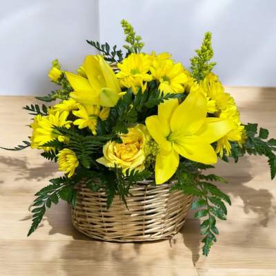 Yellow floral arrangement in a wicker basket