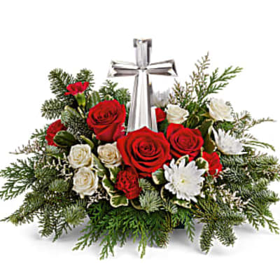 Red and white roses arranged around a silver cross
